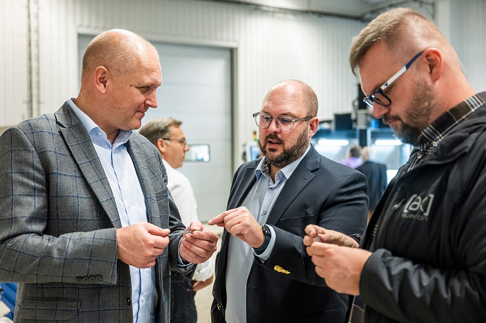 Participants take a closer look at the results of the micro waterjet cutting.